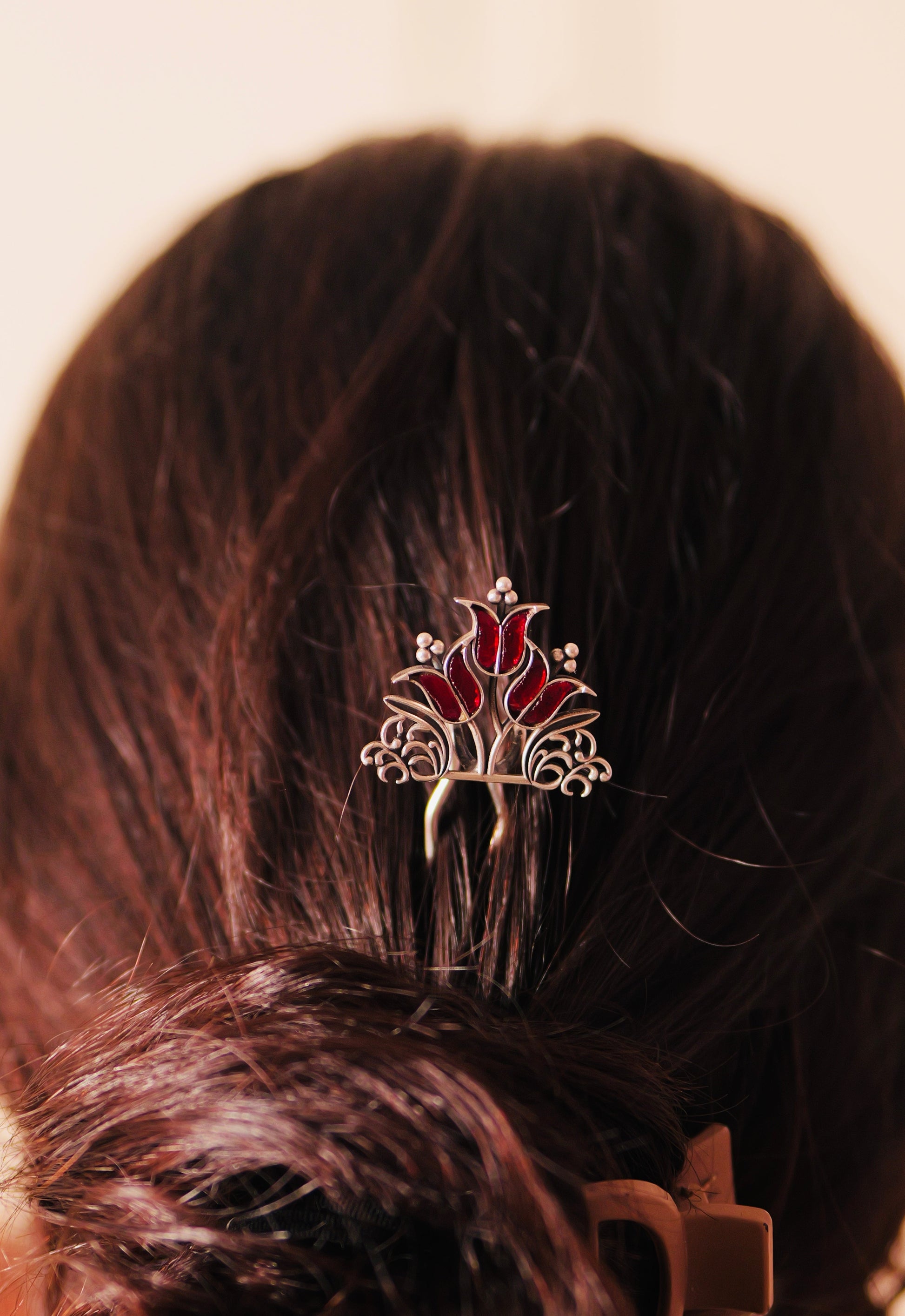Woman wearing Traditional Silver Kundan Juda Pin in Low Bun Hairstyle for Wedding